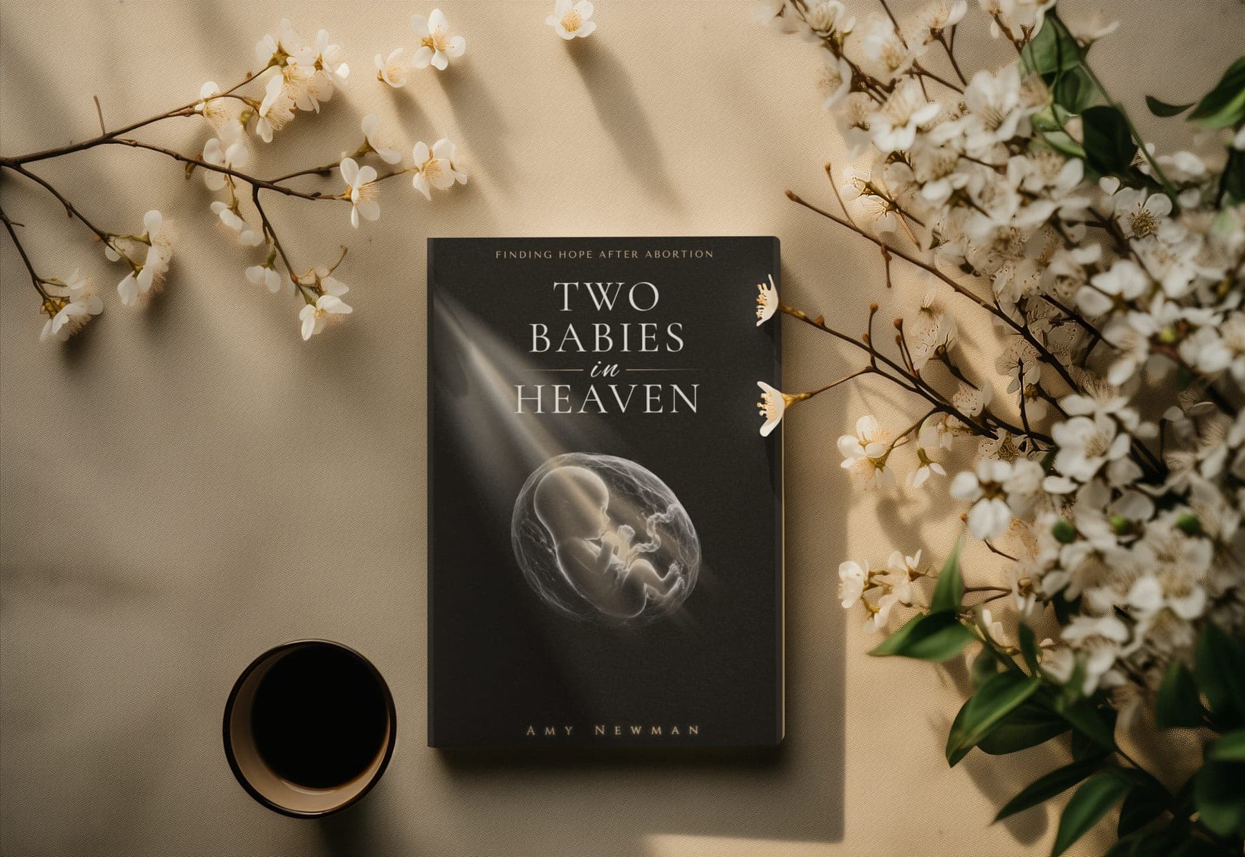 Two Babies in Heaven by Amy Newman, shown with white blossoms